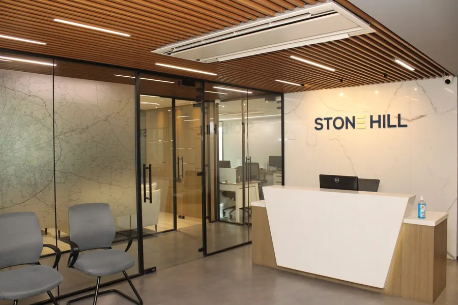 Reception desk with the Stone Hill sign at the Manikonda office