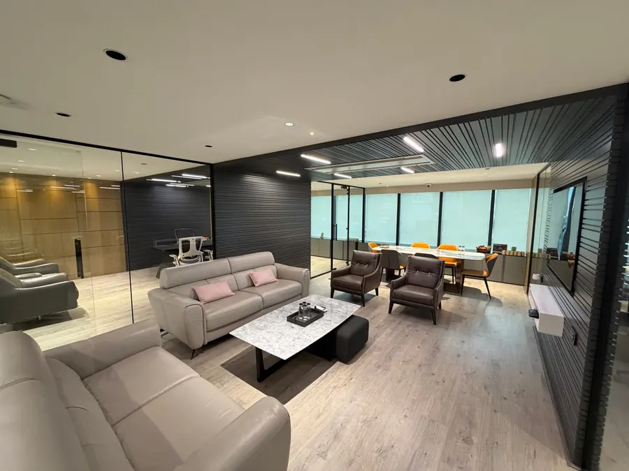 Lounge seating with the meeting table behind, at the Stone Hill office
