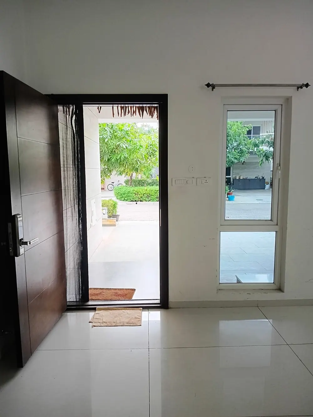 Main door of the Green Dale villa opening onto the covered porch and front garden