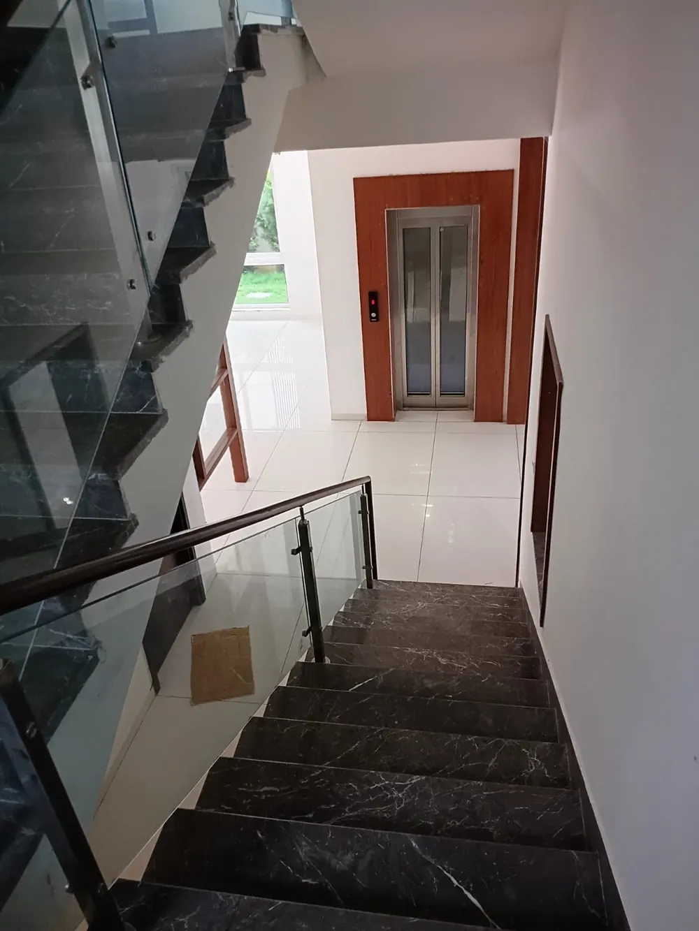 Marble staircase of the Green Dale villa leading down to the lift landing