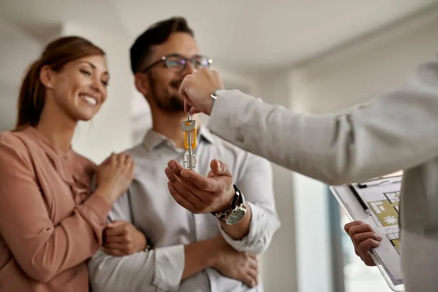 A couple receiving the keys to their new rental home