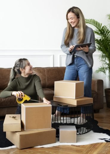 Small business friend partners packing product parcels for deliv Small business friend partners packing product parcels for delivery